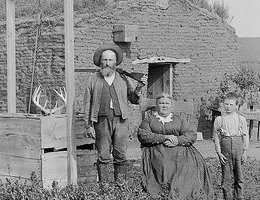 James McCrea with rifle, Mrs. McCrea, grandson George McCrea, Mr. Juker on the reaper. South of the Middle Loup River, near Berwyn, Custer County, Nebraska, 1888