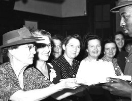 Lyda Swenson of North Platte presents Army PFC Clifton Hill of San Luis Obispo, California, a cake in 1942 as Sutherland, Nebraska, women look on