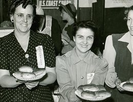 Some of the 1943 North Platte Canteen officers display ham sandwiches prepared for those in uniform