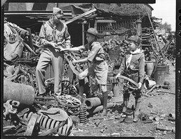 "Junior Commando" Boy Scouts in a scrap metal pile, Lincoln, 1943