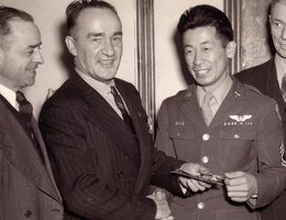 Ben Kuroki is welcomed by Tom Parker into the Veteran of Foreign Wars in Omaha, Nebraska in 1944. Others in photo unidentified. Photo by the War Relocation Authority.