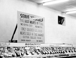 Sign over meat counter in grocery store, 1950s