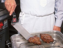 Researcher Chris Calkins grilling up a flat iron steak, 2008