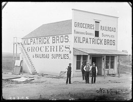 Men in front of Kilpatrick Bros. Groceries & Railroad Supplies, Broken Bow, Nebraska, 1886