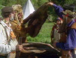 Dramatization of a fur trader rendezvous, examining beaver pelts