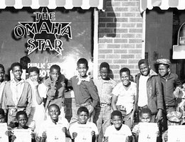 Young men in front of "The Omaha Star"