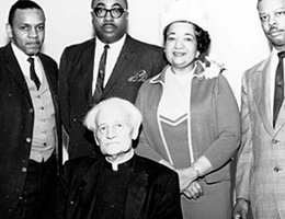 Father John Markoe, seated, and Mildred Brown, second from right, with other adult members of the DePorres Club