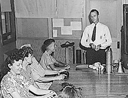 Cornhusker Ordnance Plant Photos: "At the orientation meeting, the banner says women ordnance workers are ’WOWS!’ "