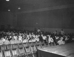 View of attendance at a movie in the Permanent Recreation Building. Note that the seating is segregated with white service people on the left and blacks on the right. US Naval Ammunition Depot, Hastings, Nebraska; circa 1944.