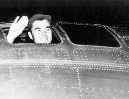 Col. Tibbets, pilot of the plane that dropped the atomic bomb on Hiroshima, waves from his cockpit before the takeoff, August 6, 1945