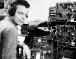 Cpl. Roger Peters in front of radio transmitters, 1940s