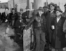 Striking Armour Co. packinghouse workers try to keep warm in south Omaha, 1948