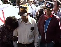 A farm family who lost their land attending a strike in the 1980s