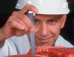 Researcher Chris Calkins inspecting a flat iron steak